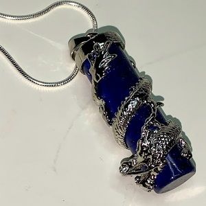 Cylindrical lapis lazuli and silver pendant.